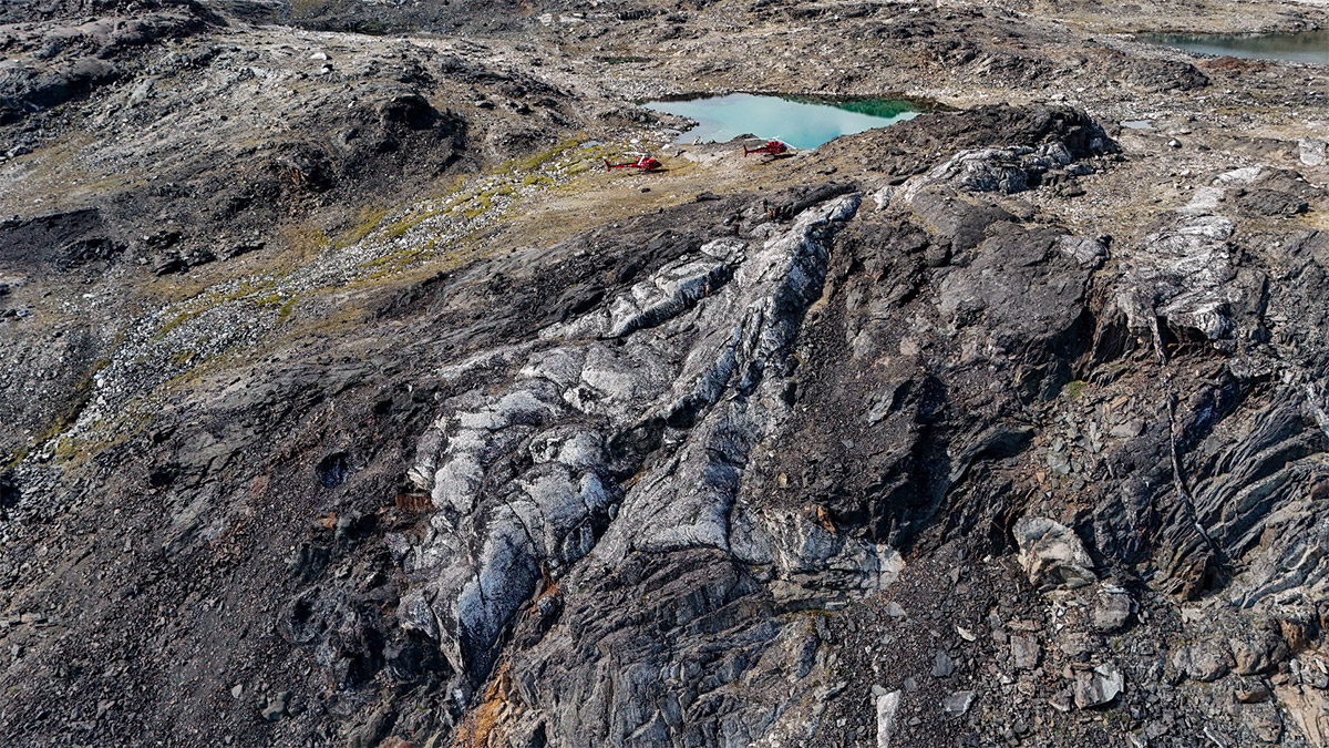Figure 2: One of the 2025 Spodumene Discovery Outcrops. Helicopters for Scale.